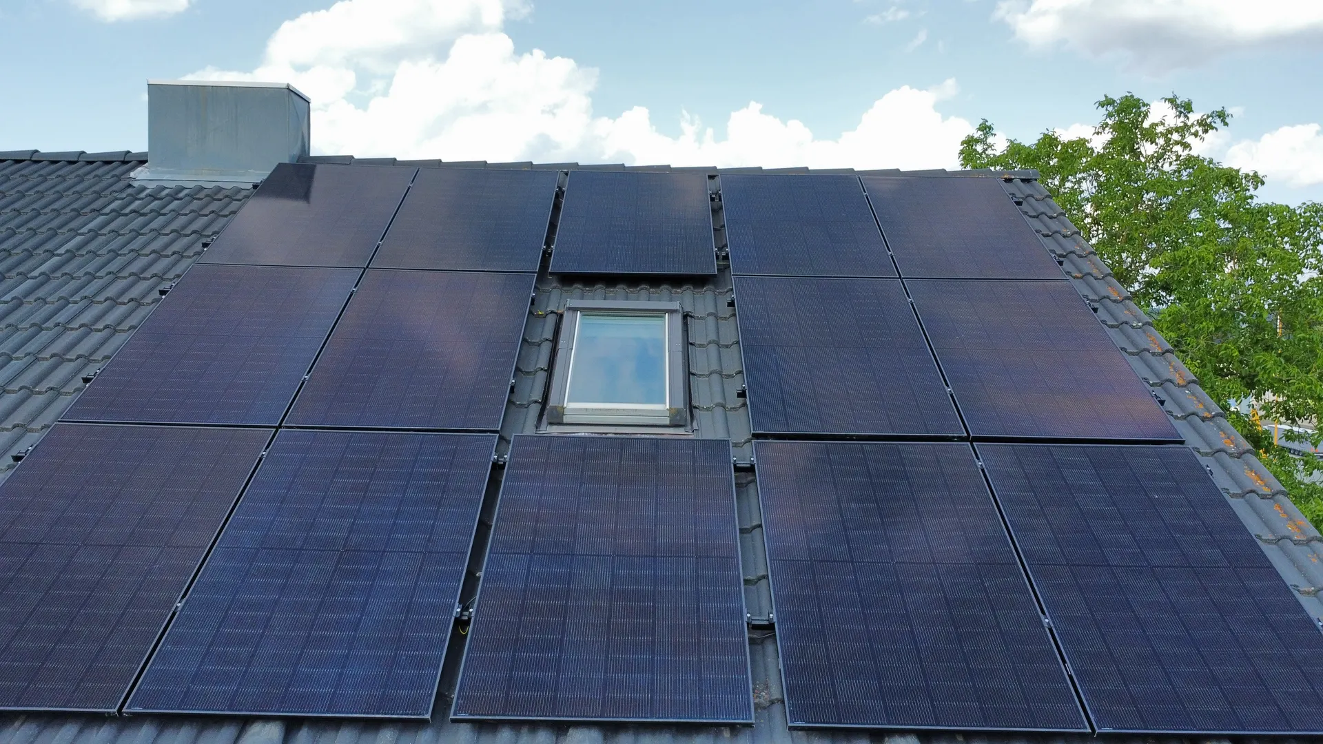 Completed photovoltaic system on a pitched roof in low afternoon light, a real installation by the company